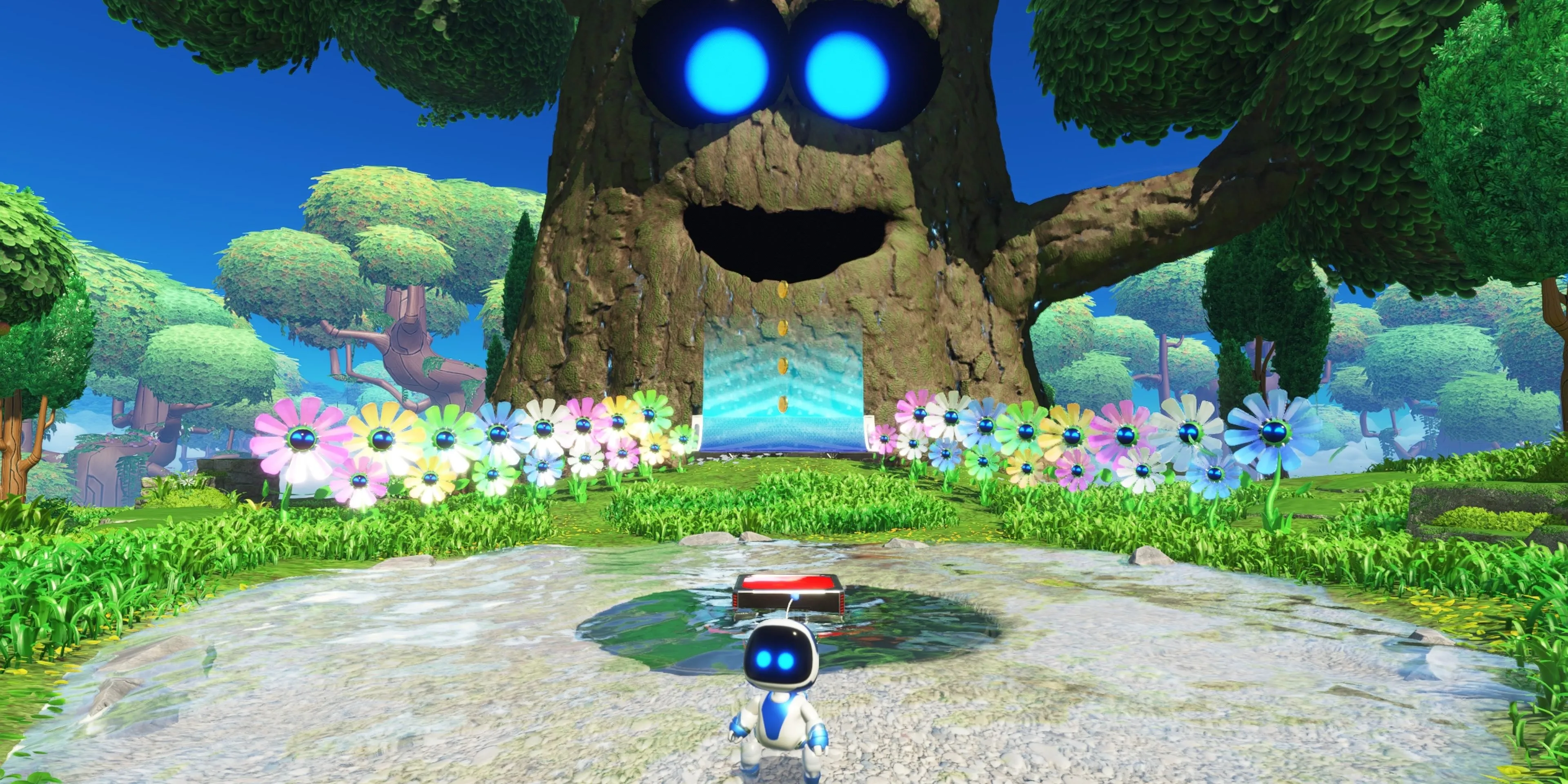 Astro Bot đứng trước cây cối trong môi trường game đầy màu sắc