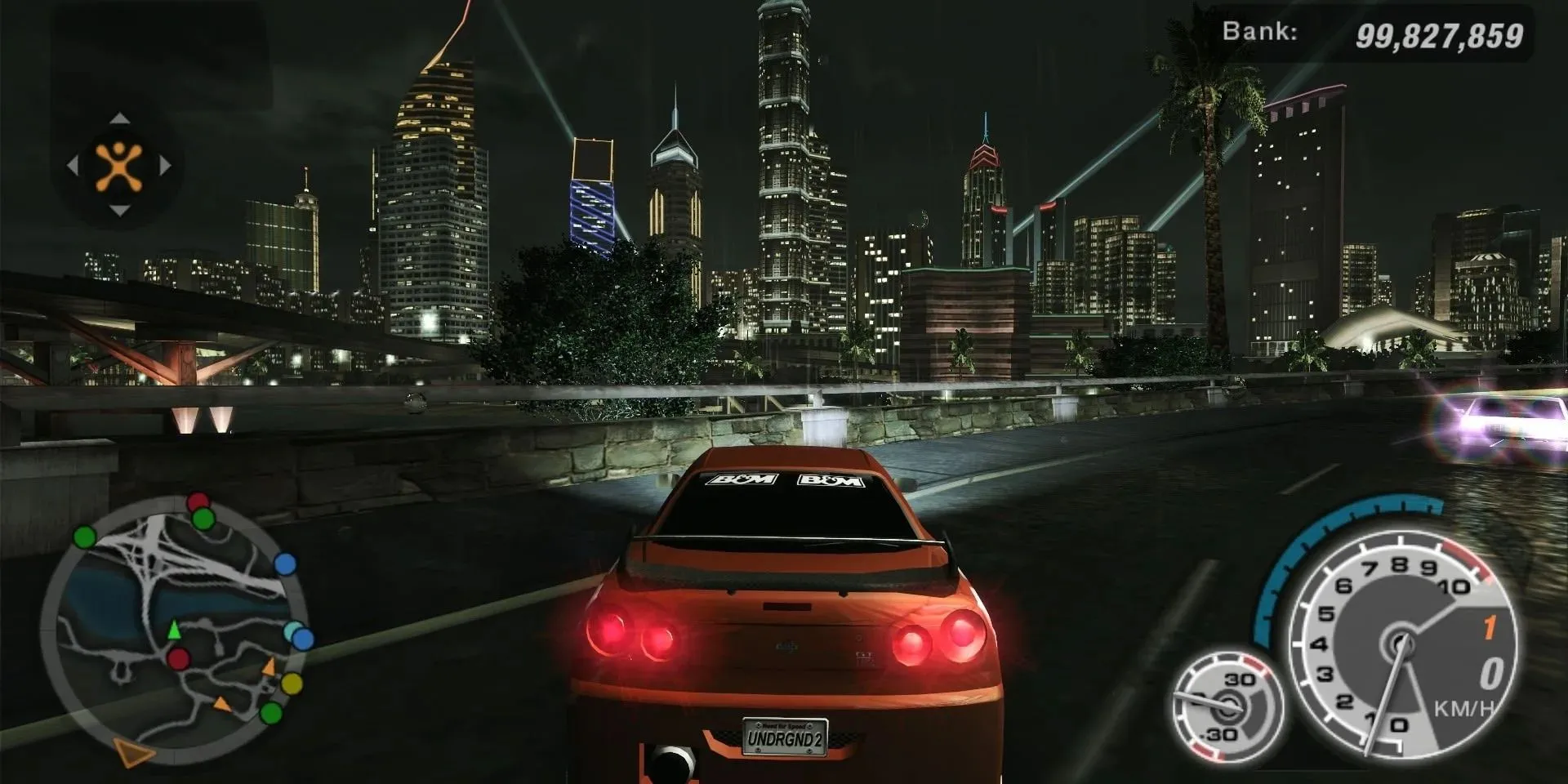 Cảnh đua xe ban đêm trong Need For Speed Underground 2 trên PS2 với chiếc Nissan Skyline trên đường cao tốc thành phố