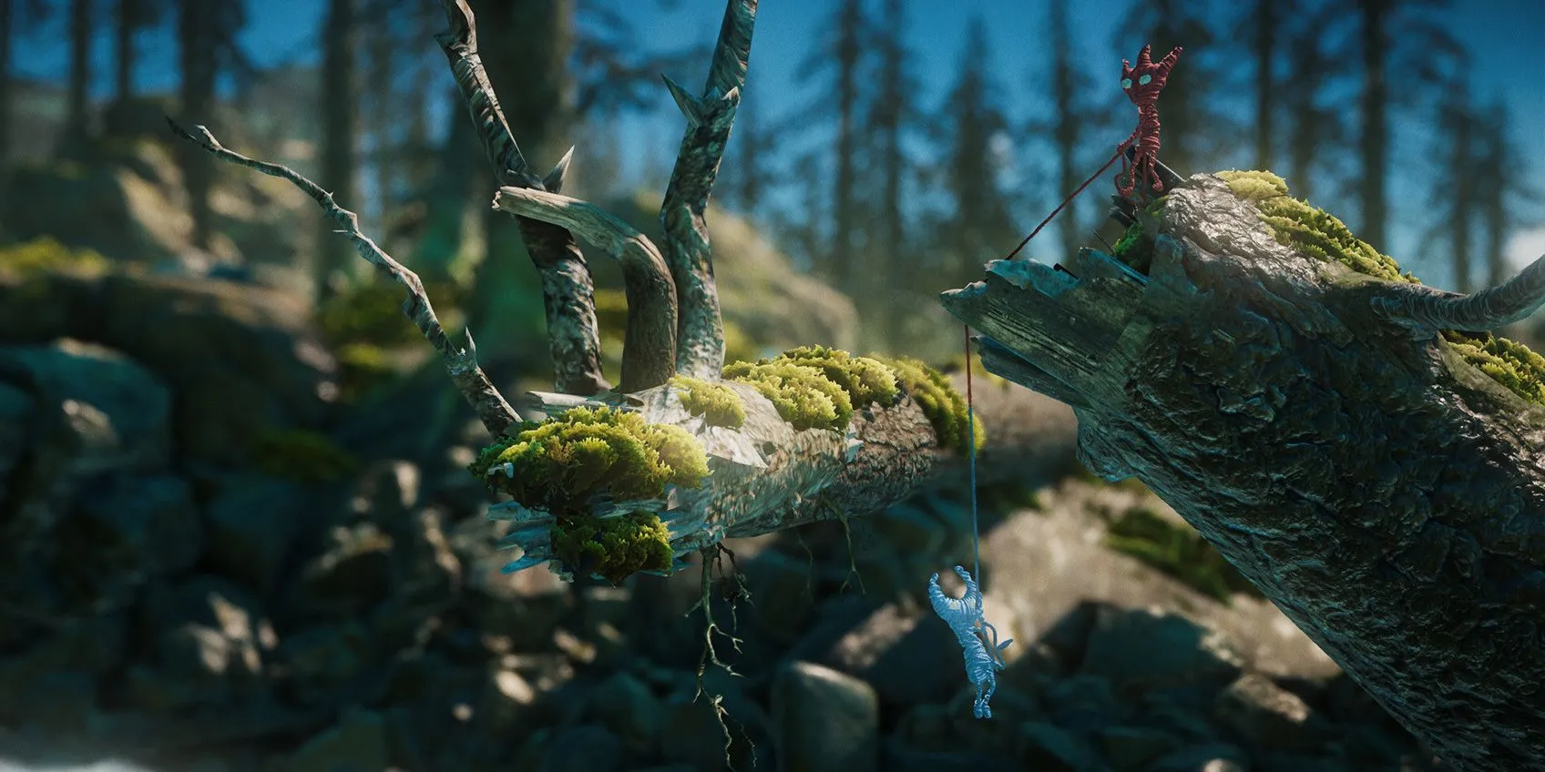 Hai nhân vật làm từ sợi len giúp đỡ nhau trong game Unravel Two