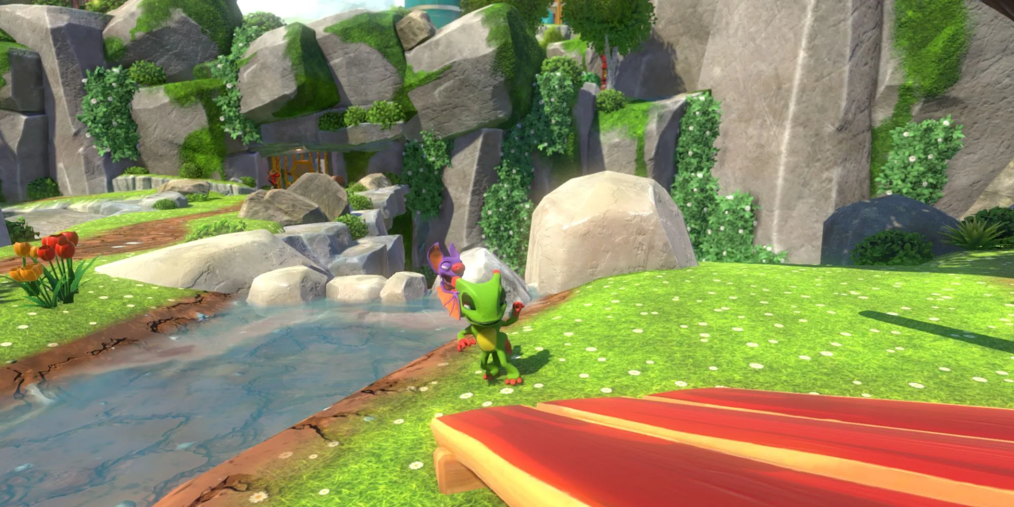 Hai nhân vật Yooka và Laylee đứng cạnh một dòng sông trong thế giới đầy màu sắc của game