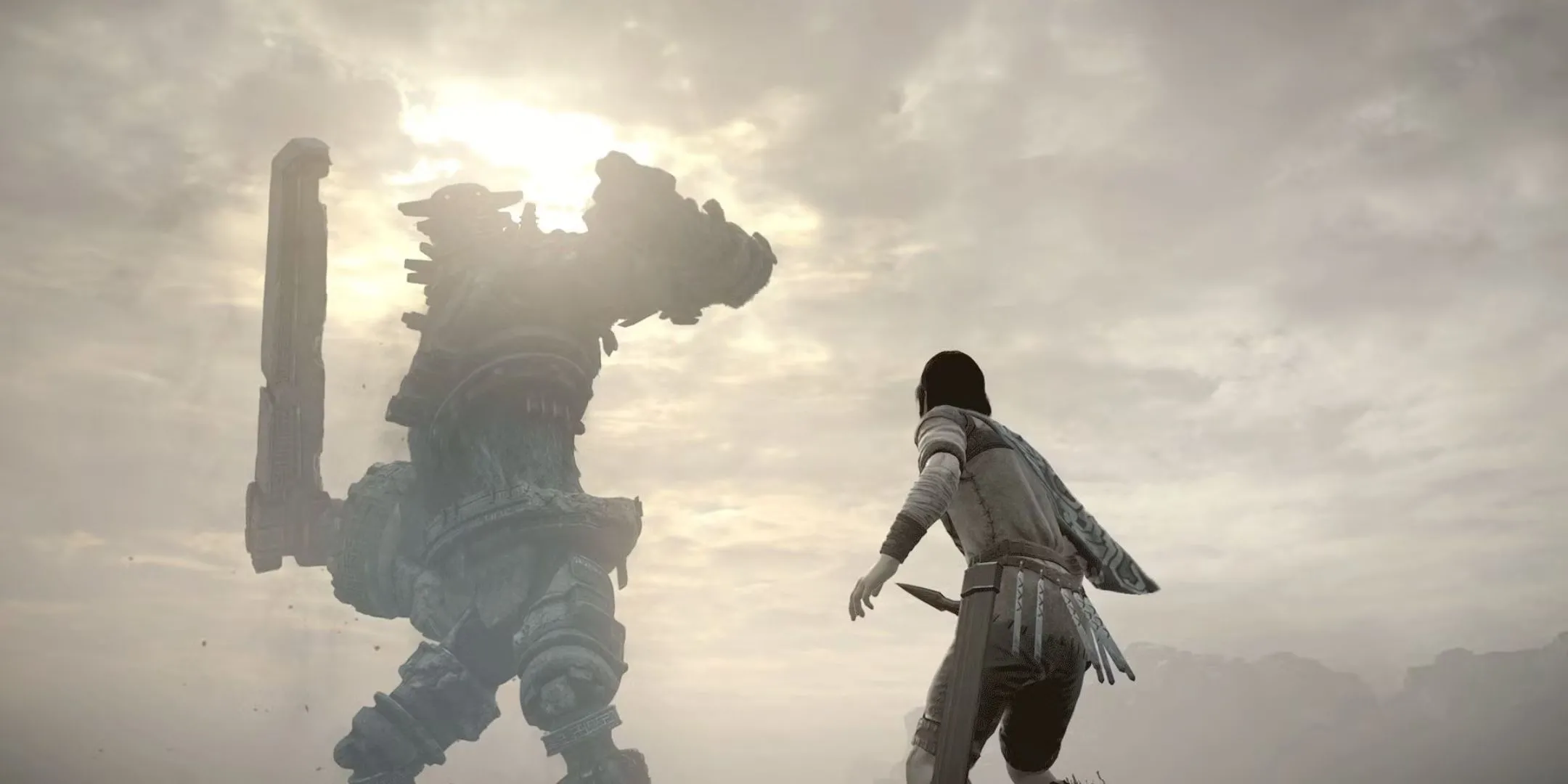 Nhân vật chính trong Shadow of the Colossus đứng trước một Colossus khổng lồ với thanh kiếm sẵn sàng chiến đấu