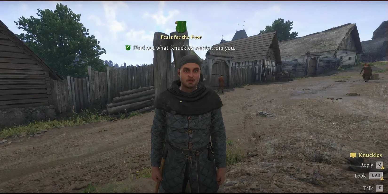 Nhân vật Knuckles, một tên trộm mặc đồ xám, đứng bên ngoài quán rượu trong Kingdom Come Deliverance 2