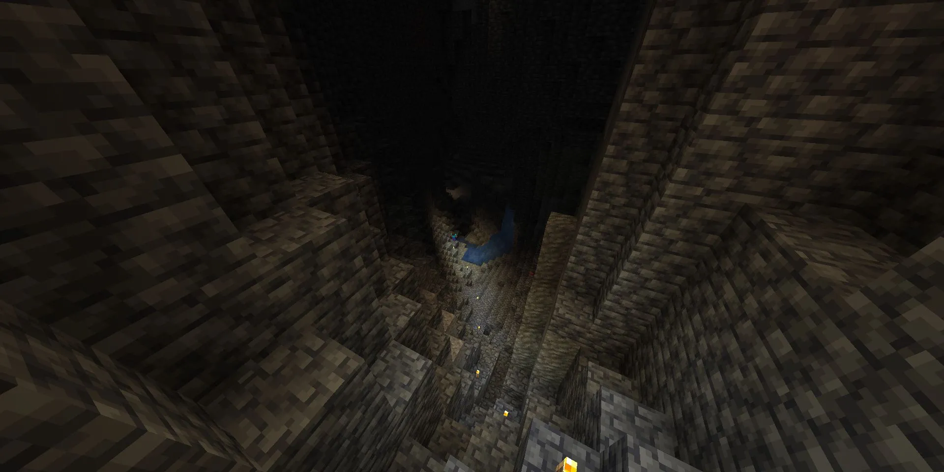 Nhân vật Steve thám hiểm hang động mới rộng lớn được thắp sáng bằng đuốc trong Minecraft