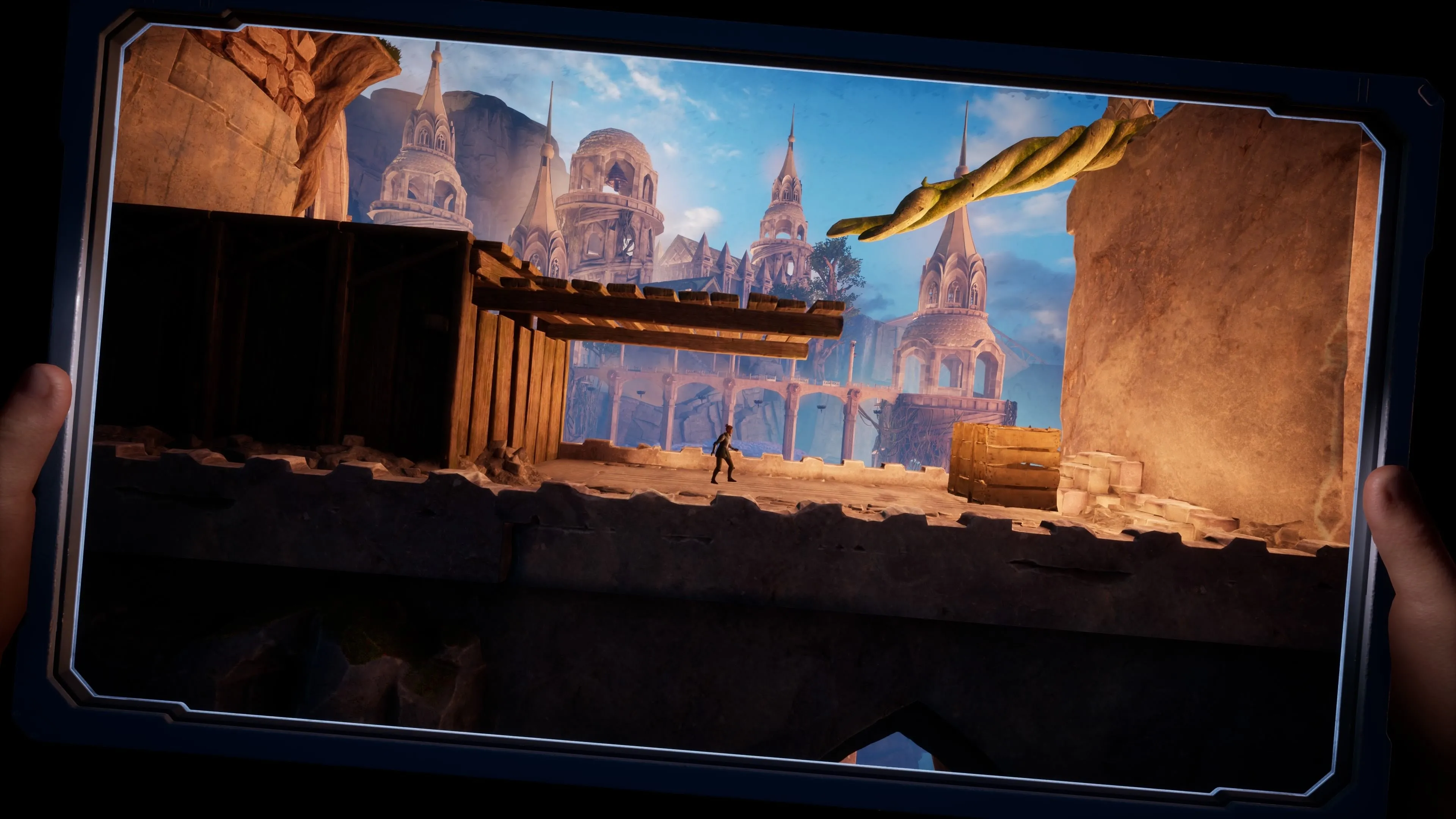 Tiêu đề phụ chương &quot;Outside The Box&quot; trong game Split Fiction với hình ảnh Zoe bị kẹt trong máy tính bảng và Mio điều khiển