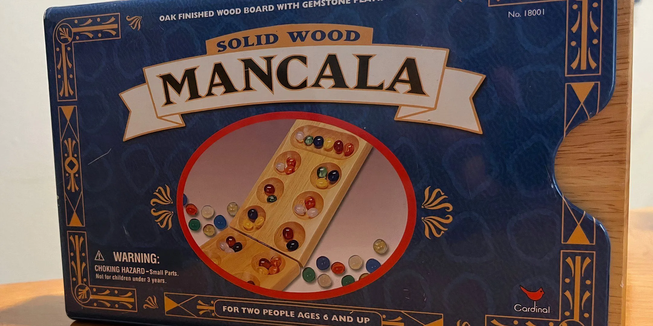 Bìa hộp game Mancala, một trong những board game cổ xưa nhất thế giới