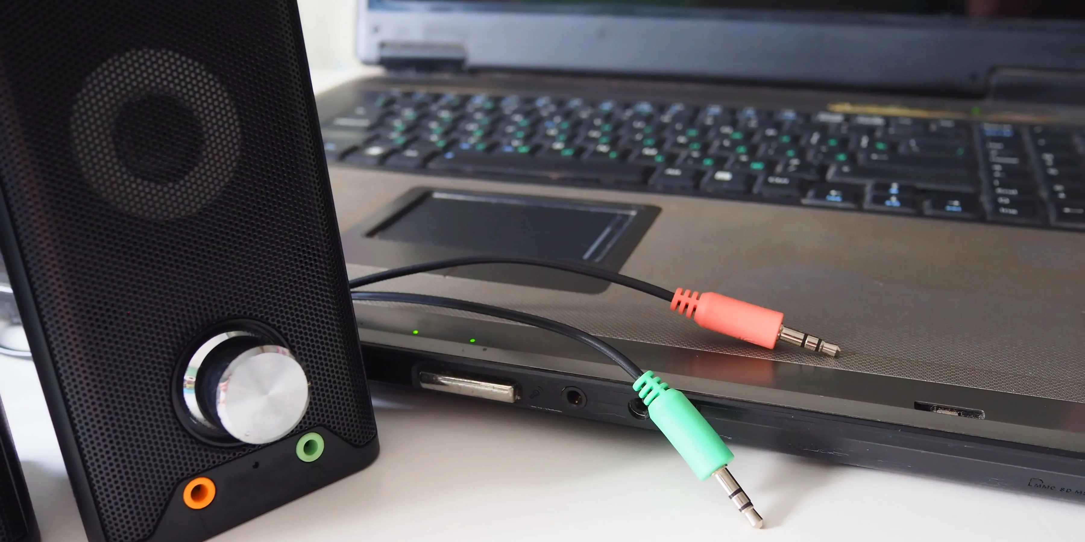 Loa máy tính với nhiều dây cáp audio 3.5mm kết nối với thùng PC, cho thấy sự phức tạp của hệ thống dây